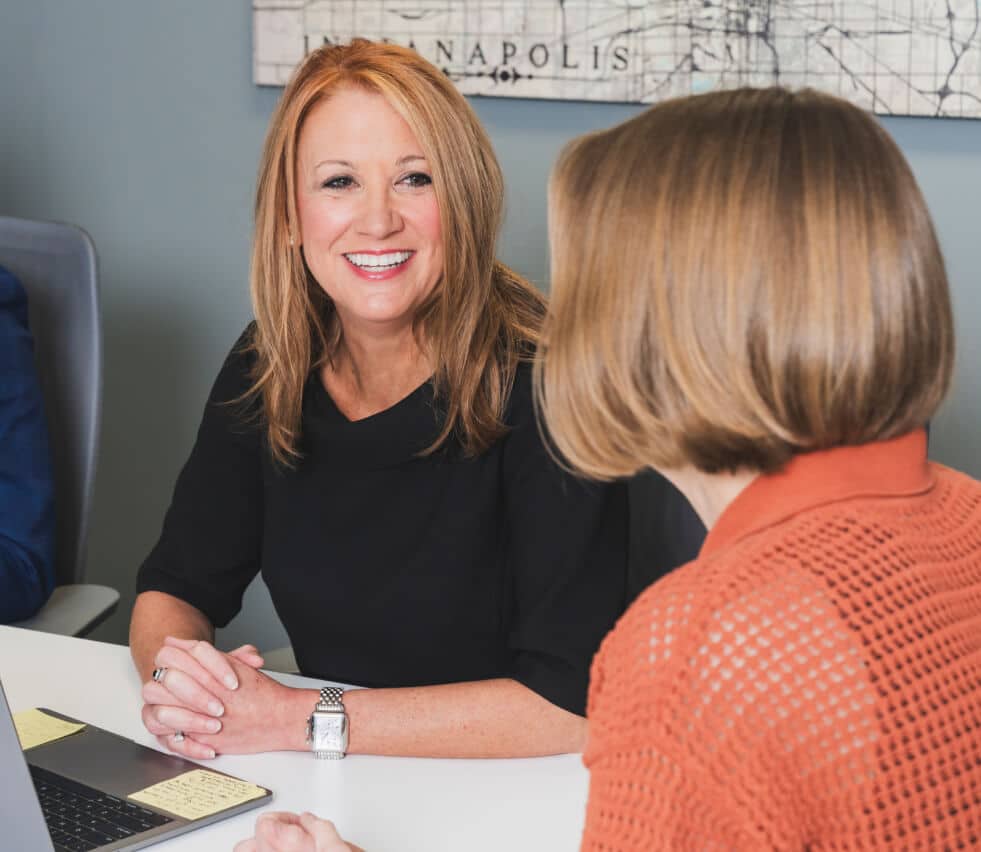 Jennifer Hallowell smiling while meeting with Molly Gillaspie